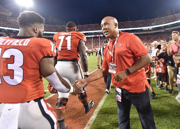 October 6, 2018 Athens - Former Georgia Bulldog Hines Ward greets Georgia running back Elijah Holyfield (13) before a NCAA college football game at Sanford Stadium in Athens on Saturday, October 6, 2018. HYOSUB SHIN / HSHIN@AJC.COM