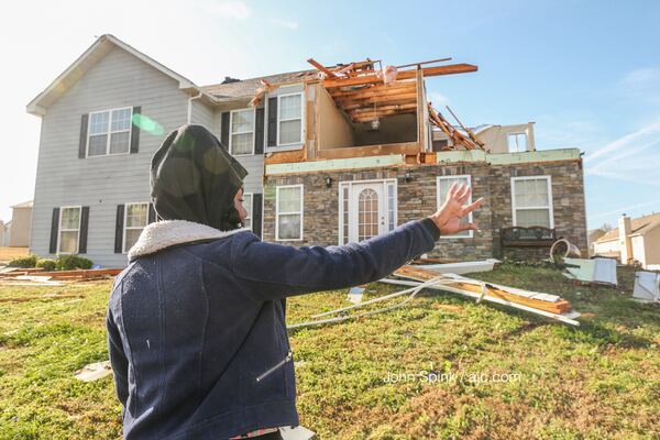 Khadijah Muhammad surveys the damage in Jumpers Trail. JOHN SPINK / AJC