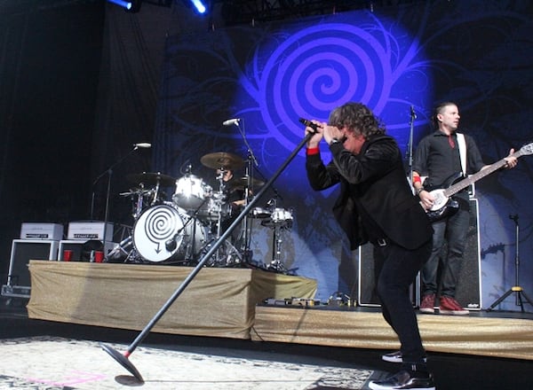 Ed Roland leans in during Collective Soul's set opening for the Goo Goo Dolls Sunday at Chastain Park Amphitheatre. Photo: Melissa Ruggieri/AJC