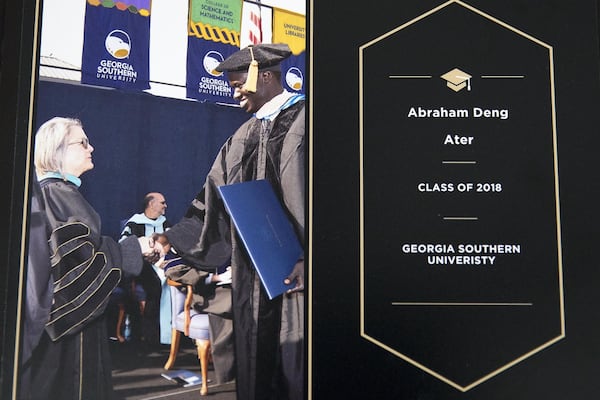 This photo shows Abraham Deng Ater during his doctor of public health hooding ceremony at Georgia Southern University. Ater, already working for the CDC, hopes to use his skills someday to help his homeland, South Sudan. ALYSSA POINTER / ALYSSA.POINTER@AJC.COM