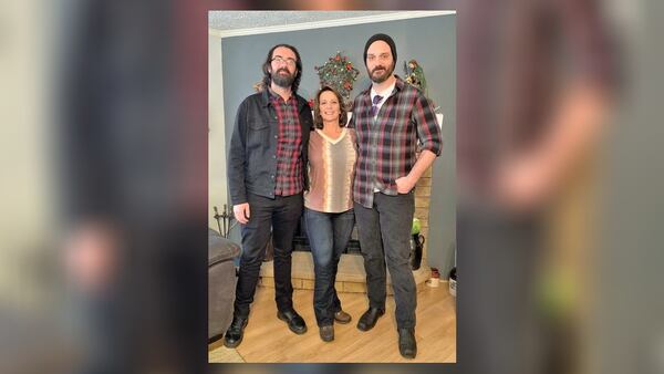 A recent photo of Tina Davis with her two sons. Davis can now walk with the assistance of crutches.