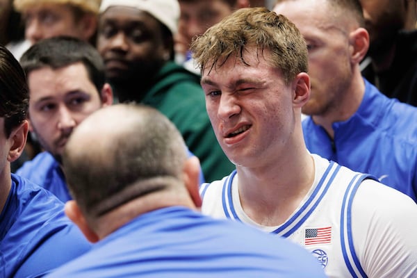 Duke's Cooper Flagg reacts on the bench after being accidentally hit in the face during the first half of an NCAA college basketball game against Florida State in Durham, N.C., Saturday, March 1, 2025. (AP Photo/Ben McKeown)