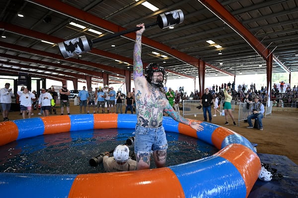 Croix Bruns, right, of Jacksonville, Fla., celebrates after defeating Chris Stinnett, of New Port Richey, Fla., in the Weaponized Pool Noodle Mud Wrestling event during the Florida Man Games, Saturday, March 1, 2025, in Elkton, Fla. (AP Photo/Phelan M. Ebenhack)