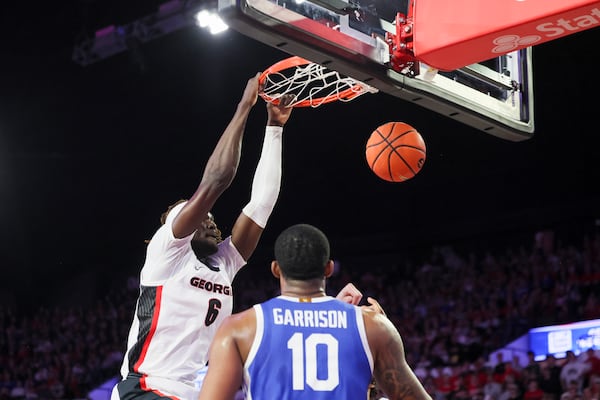 Georgia center Somto Cyril (6) dunks against Kentucky forward Brandon Garrison (10) during the first half in a NCAA men’s basketball game at Stegeman Coliseum, Tuesday, Jan. 7, 2025, in Athens, Ga. Georgia defeated Kentucky 82-69. (Jason Getz / AJC)
