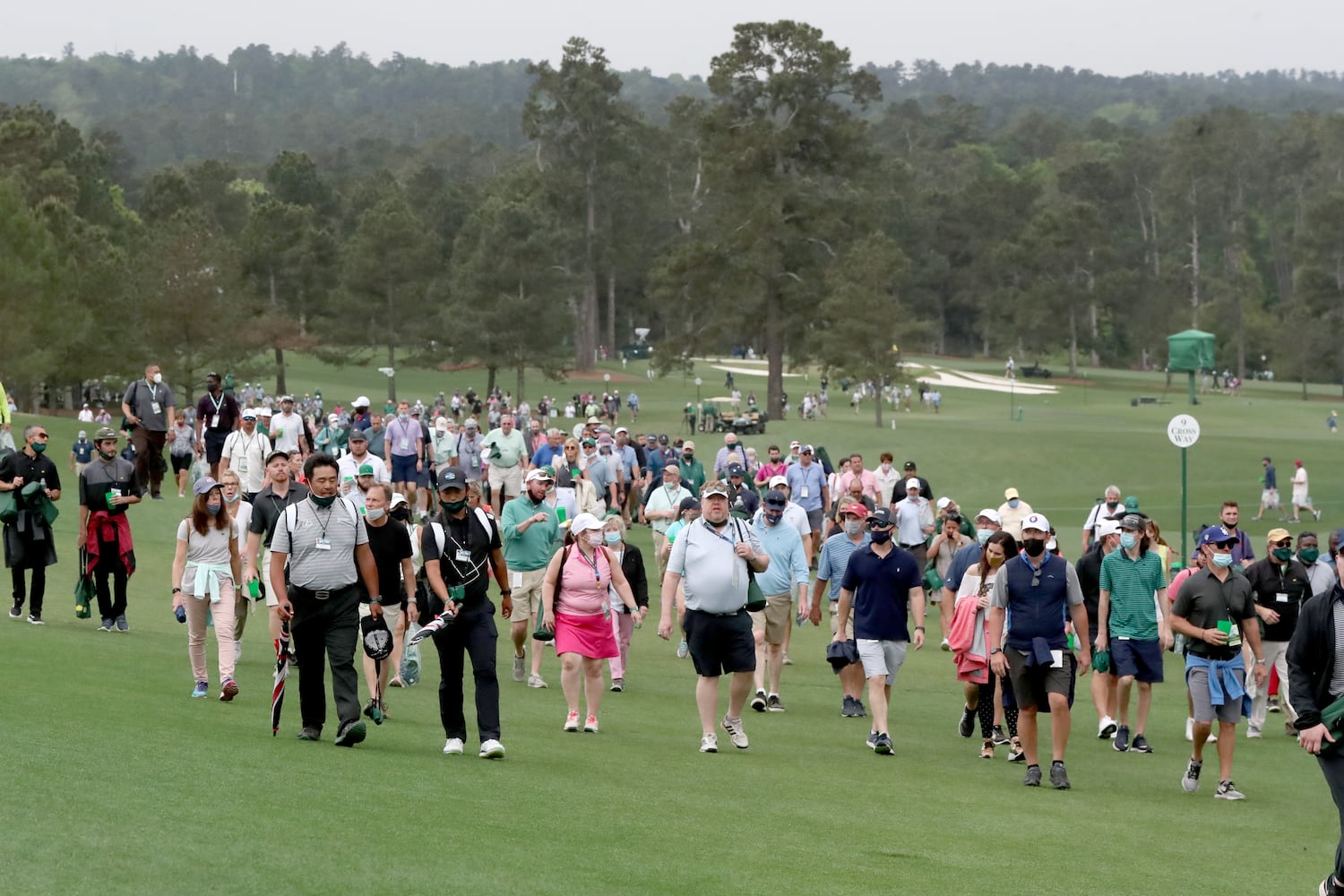 April 10, 2021, Augusta: Patrons leave the course as play is suspended because of a weather warning during the third round of the Masters at Augusta National Golf Club on Saturday, April 10, 2021, in Augusta. Curtis Compton/ccompton@ajc.com