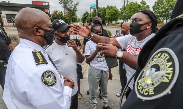 July 6, 2020 Atlanta:. Atlanta police and sanitation crews finished removing protesters and their belongings from outside the Wendy’s on Monday July 6, 2020 where Rayshard Brooks was shot and killed by an officer last month. The last concrete barricade was put in place around noon. Some of the protesters milled nearby while a worker from the BP gas station next door pulled boards off the windows. Monday’s cleanup followed a violent holiday weekend that started Saturday night when 8-year-old Secoriea Turner was fatally shot while sitting in a car near the restaurant. Atlanta Mayor Keisha Lance Bottoms denounced the violence in an emotional press conference at police headquarters in which she and Turner’s family urged people to come forward with information about the girl’s killers. About 9:30 a.m. Monday, uniformed officers and multiple workers in neon attire tossed flowers and other items from a makeshift memorial outside the Wendy’s into garbage bags. The site has served as ground zero for protests since Brooks was shot in the parking lot following an attempted DUI arrest in the drive-thru line June 12. The restaurant was destroyed during a large protest the next day. Three people have been arrested on arson charges in connection with the incident. JOHN SPINK/JSPINK@AJC.COM

