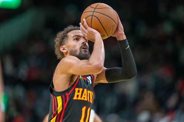 Atlanta Hawks guard Trae Young (11) attempts to make a basket during the second half of an Emirates NBA Cup basketball game against the Cleveland Cavaliers, Friday, Nov. 29, 2024, in Atlanta. (AP Photo/Erik Rank)