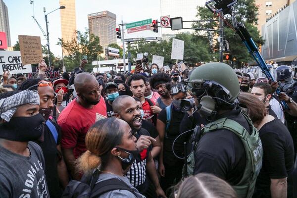 Demonstrators confronted police officers outside of the CNN Center while protesting police brutality against Black people on June 1. Protesters challenged officers of color just as readily as they stood up to their white counterparts. ALYSSA POINTER/ ALYSSA.POINTER@AJC.COM