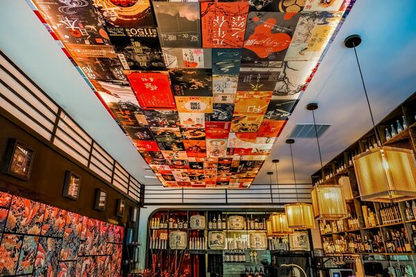 Sake bottle labels decorate the ceiling at Yakitori Kona. Courtesy of Yakitori Kona