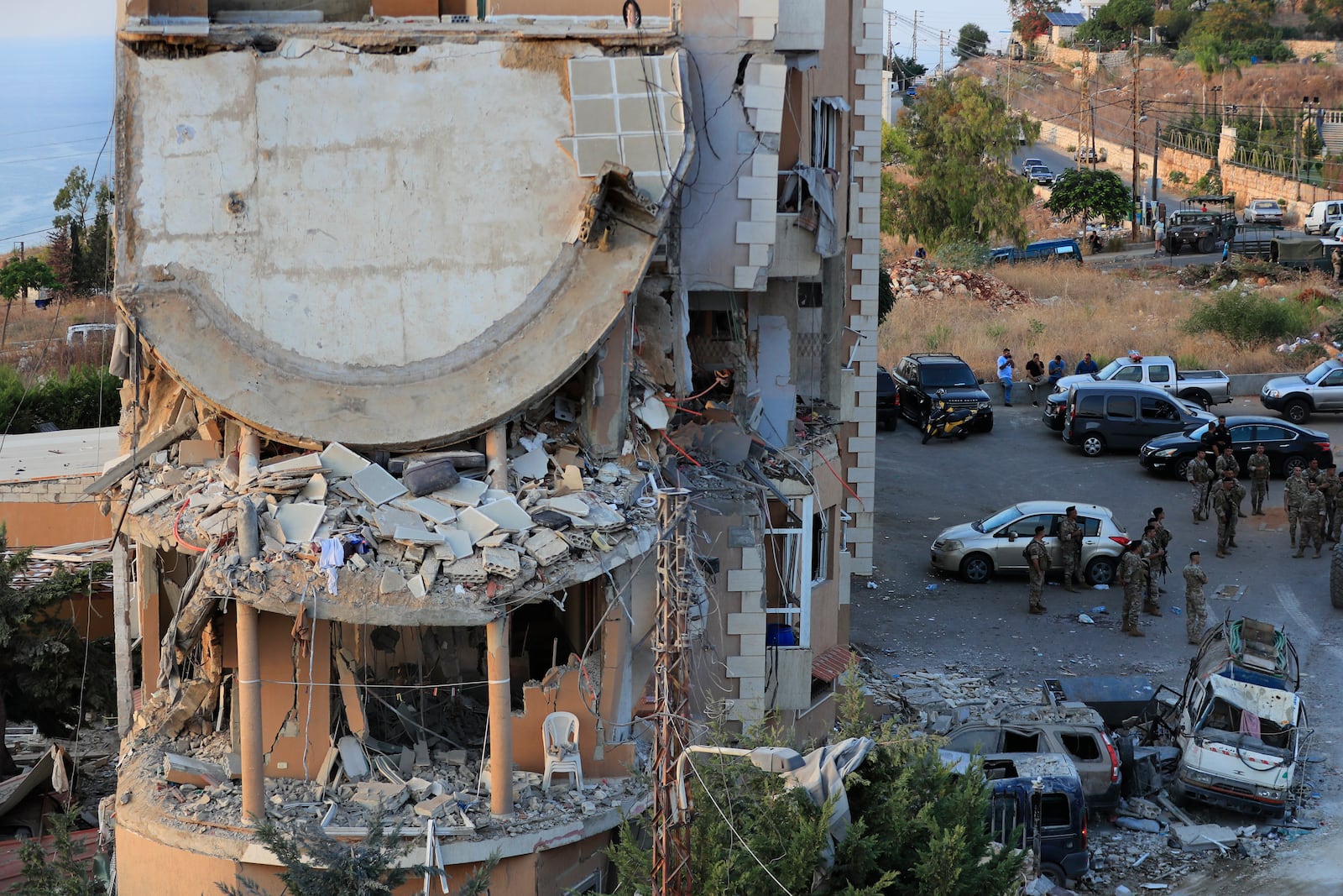 Lebanese army soldiers deploy around a destroyed building hit by an Israeli airstrike, in Barja village, south of Beirut, Lebanon, Saturday, Oct. 12, 2024. (AP Photo/Mohammed Zaatari)