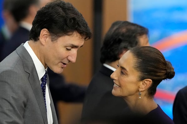 Canada's Prime Minister Justin Trudeau, left, and Mexico's President Claudia Sheinbaum talk during the G20 Summit leaders meeting in Rio de Janeiro, Monday, Nov. 18, 2024. (AP Photo/Eraldo Peres)