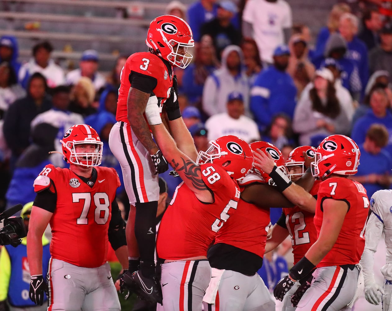 Georgia running back Andrew Paul gets a hoist from offensive lineman Austin Blaske after scoring a touchdown for a 51-13 lead over Kentucky during the fourth quarter.  Curtis Compton for the Atlanta Journal Constitution