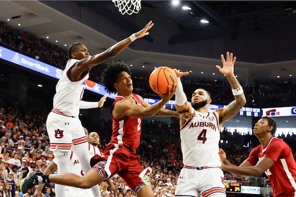 Auburn forward Johni Broome (4) blocks the shot attempt of Alabama guard Aden Holloway (2) during the first half of an NCAA college basketball game, Saturday, March 8, 2025, in Auburn, Ala. (AP Photo/Butch Dill)