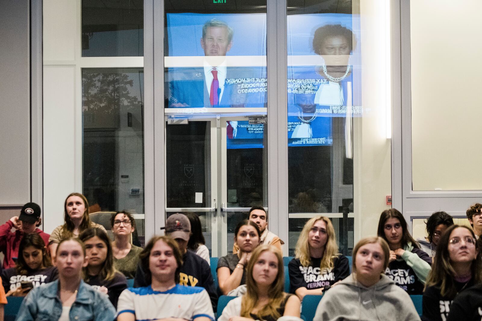 Students attend a watch party at Emory University to see the gubernatorial debate between Democrat Stacey Abrams, Libertarian Shane Hazel and Republican Gov. Brian Kemp. (Gabriela Bhaskar/The New York Times).