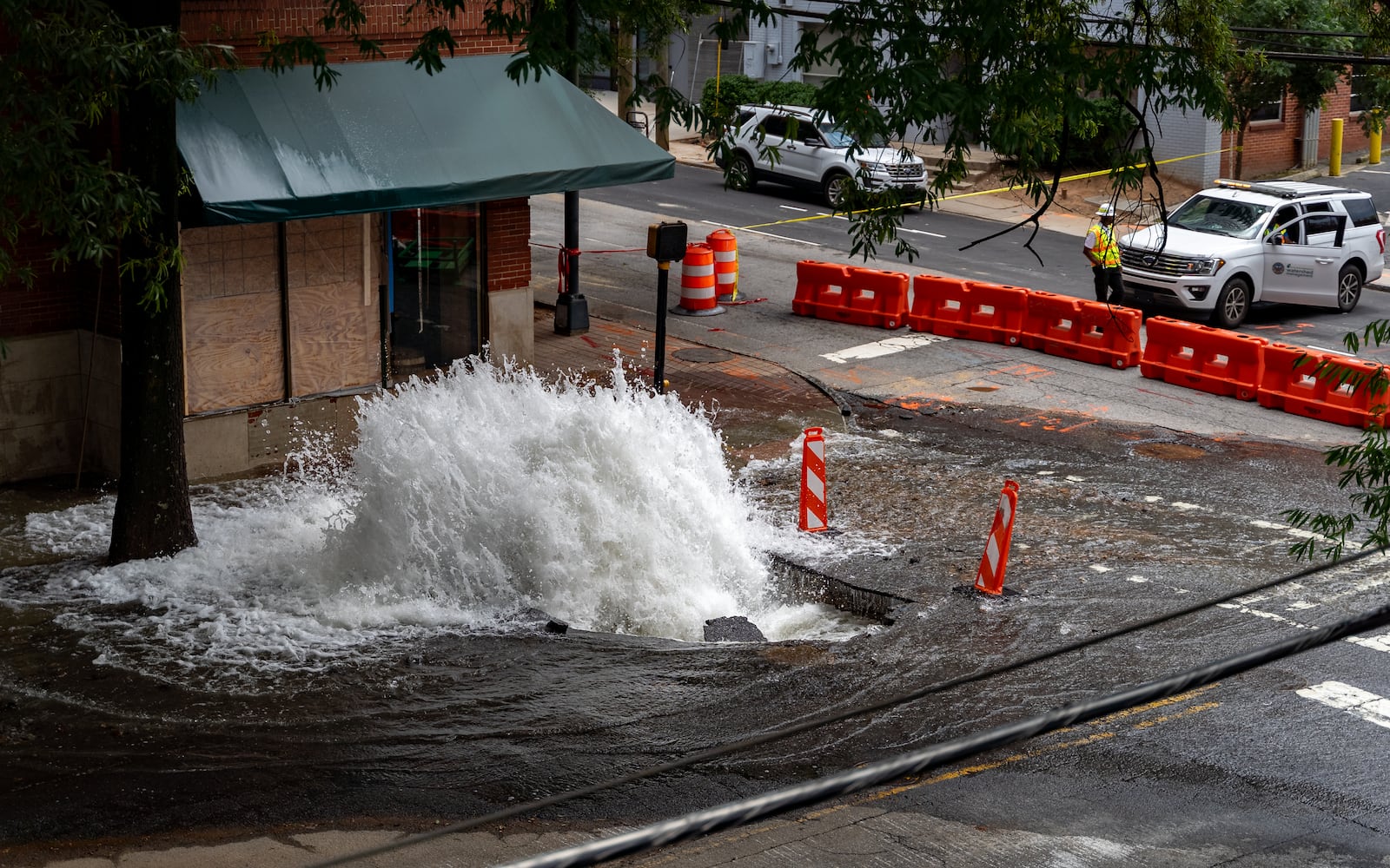 Water continues to flood out of the broken water main