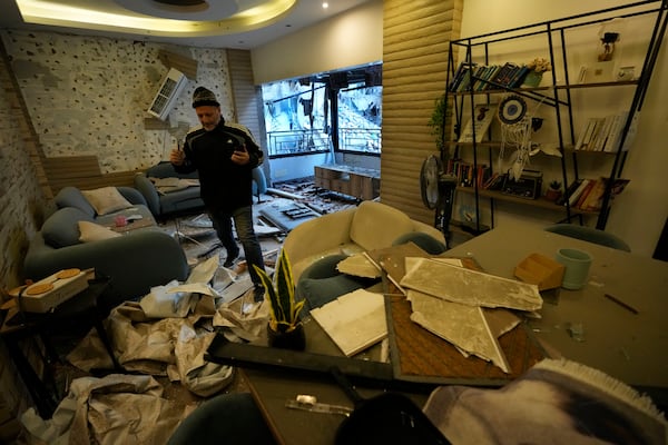 A man checks his damaged apartment which was resulted from Sunday's Israeli airstrike in Dahiyeh, in the southern suburb of Beirut, Lebanon, Monday, Nov. 25, 2024. (AP Photo/Hussein Malla)