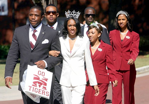 Morehouse student body president Stanley Onuoha, a senior from Boston, escorts Miss Maroon and White, Kera Street, a senior from Richmond, Virginia, as they walk to the stadium before their game in this 2007 file photo.