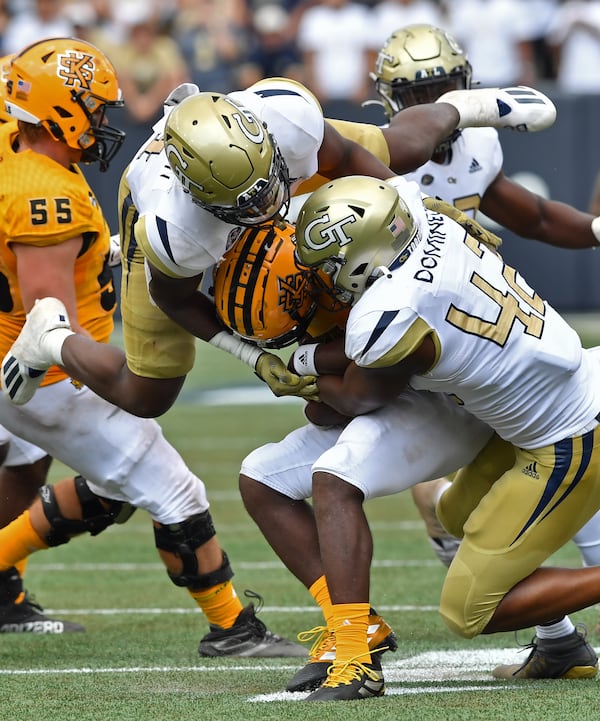 Kennesaw State quarterback Xavier Shepherd (8) gets tackled by Georgia Tech linebacker Quez Jackson (4) and defensive lineman Jordan Domineck (42) during the second half Saturday, Sept. 11, 2021, at Bobby Dodd Stadium in Atlanta. (Hyosub Shin / Hyosub.Shin@ajc.com)