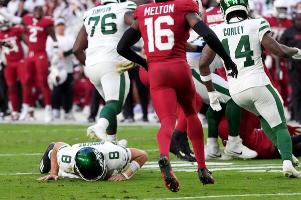 New York Jets quarterback Aaron Rodgers (8) lies on the turf during the second half of an NFL football game against the Arizona Cardinals, Sunday, Nov. 10, 2024, in Glendale, Ariz. (AP Photo/Ross D. Franklin)