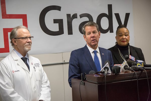 Georgia Governor Brian Kemp holds a press conference flanked by Chief Medical Officer Dr. Robert Johnson (left) & Chief Nursing Officer Dr. Jackie Herd inside a mobile hospital after touring the damaged cause by a broken water main at Grady Memorial Hospital. (Photo by Phil Skinner).