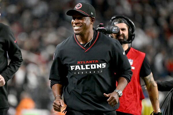 Atlanta Falcons head coach Raheem Morris smiles during the first half of an NFL football game against the Las Vegas Raiders, Monday, Dec. 16, 2024, in Las Vegas. (AP Photo/David Becker)