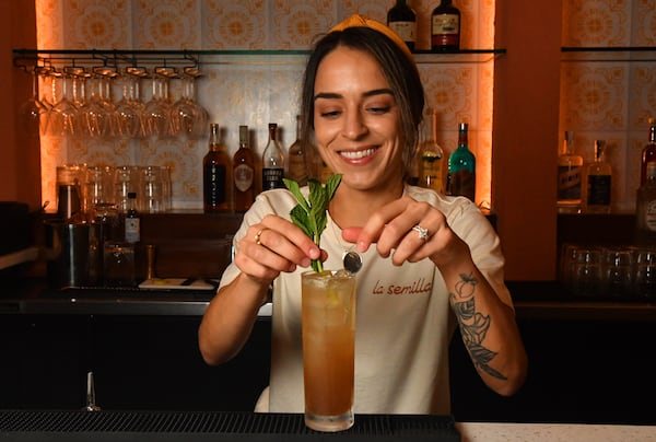 Sophia Trapani makes a mojito at the bar of La Semilla, located in the Modera development on Memorial Drive in Reynoldstown. (CHRIS HUNT FOR THE ATLANTA JOURNAL-CONSTITUTION)