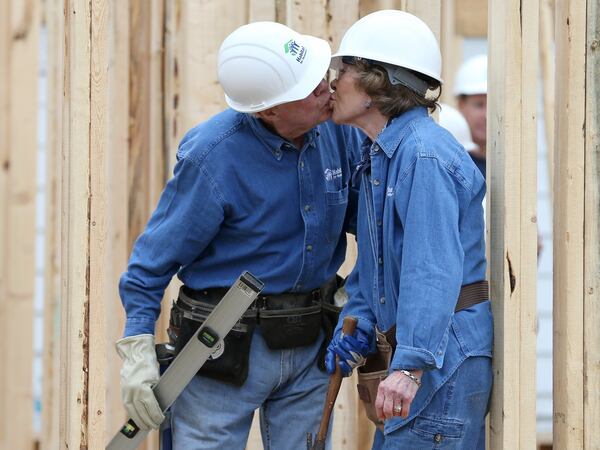 2015: Jimmy Carter sneaks a kiss with Rosalynn while the couple works on a Habitat for Humanity build in Memphis. (Ben Gray / bgray@ajc.com)