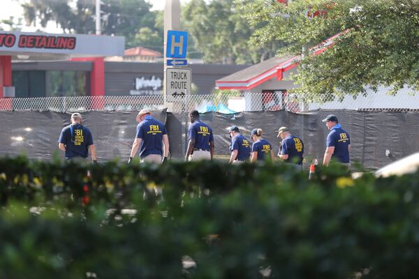 FBI investigators process the scene near Pulse nightclub in Orlando. AJC photos: Curtis Compton