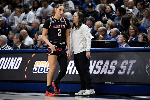 Arkansas State head coach Destinee Rogers, right, talks with Arkansas State guard Wynter Rogers (2) during the first half in the first round of the NCAA college basketball tournament, Saturday, March 22, 2025, in Storrs, Conn. (AP Photo/Jessica Hill)