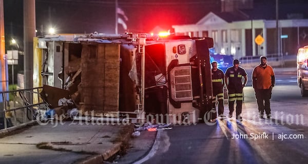 The garbage truck tipped on its side and was blocking the westbound lanes of Lawrenceville Highway near the entrance to I-285.