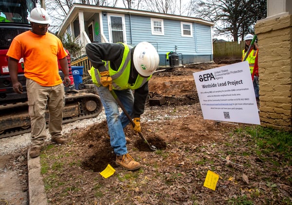 Workers remove contaminated dirt from a property in the Westside Lead Superfund site last week. The EPA cleanup of the site, located in a historic Black community, could last until 2028 or 2029. (Steve Schaefer for The Atlanta Journal-Constitution)