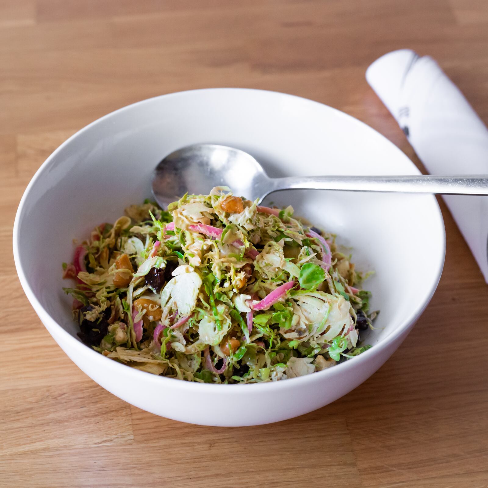 Emmy Squared Pizza’s Brussels sprouts salad is a nice sweet, salty, crunchy pile of shaved Brussels sprouts, pickled red onion, cashews, blue cheese, dried cherry and miso dressing. (Courtesy of Emmy Squared Pizza)