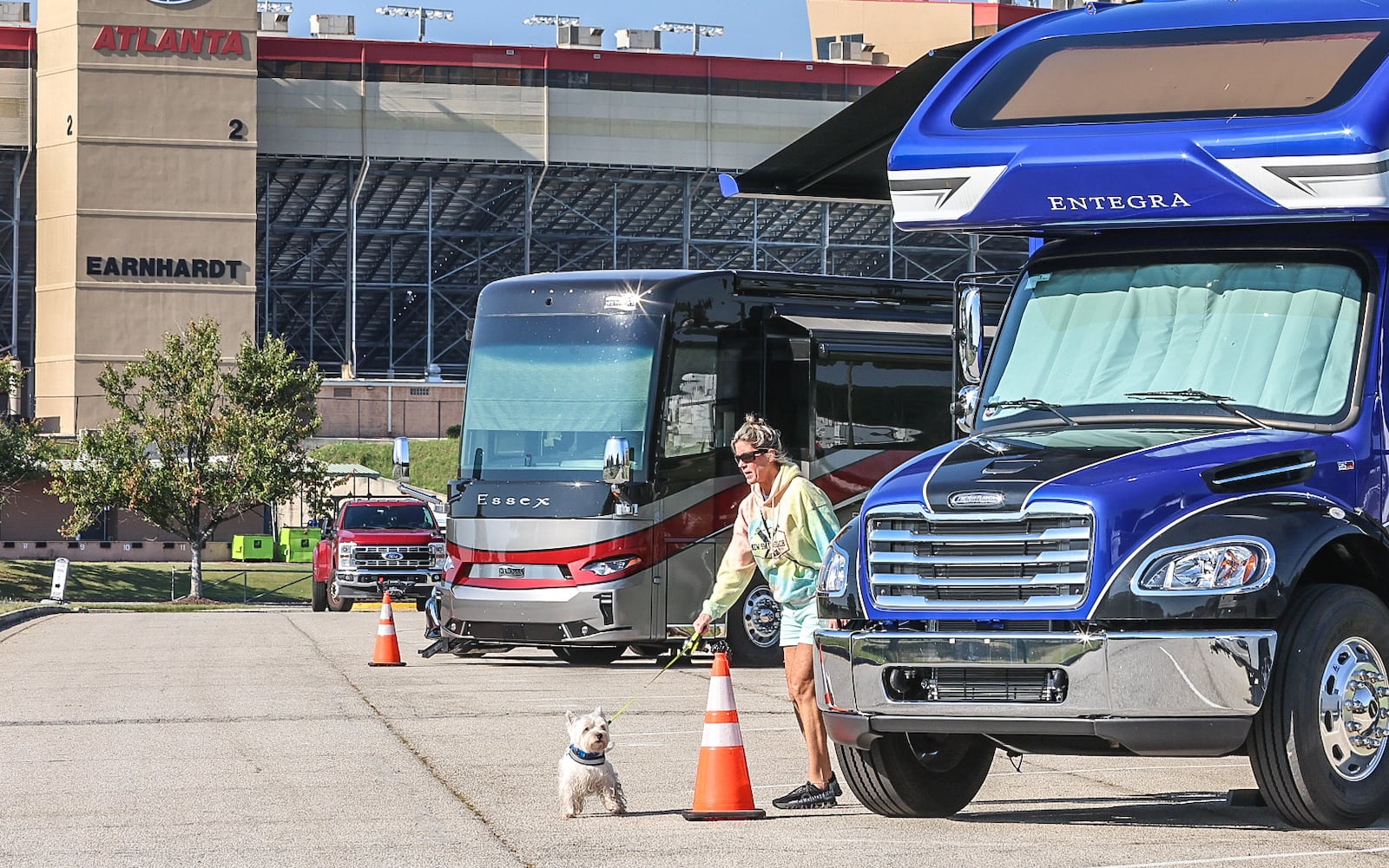 Hurricane Milton evacuee Paula Williams walks her dog at the Atlanta Motor Speedway on Tuesday after fleeing their home in Clermont, Florida.