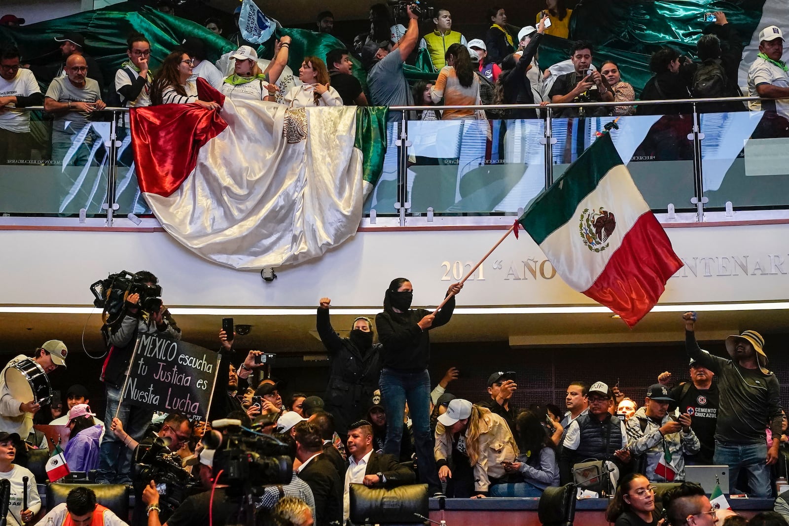 Protesters interrupt a Senate session in which lawmakers were debating the government's proposed judicial reform, which would make judges stand for election, in Mexico City, Tuesday, Sept. 10, 2024. (AP Photo/Felix Marquez)