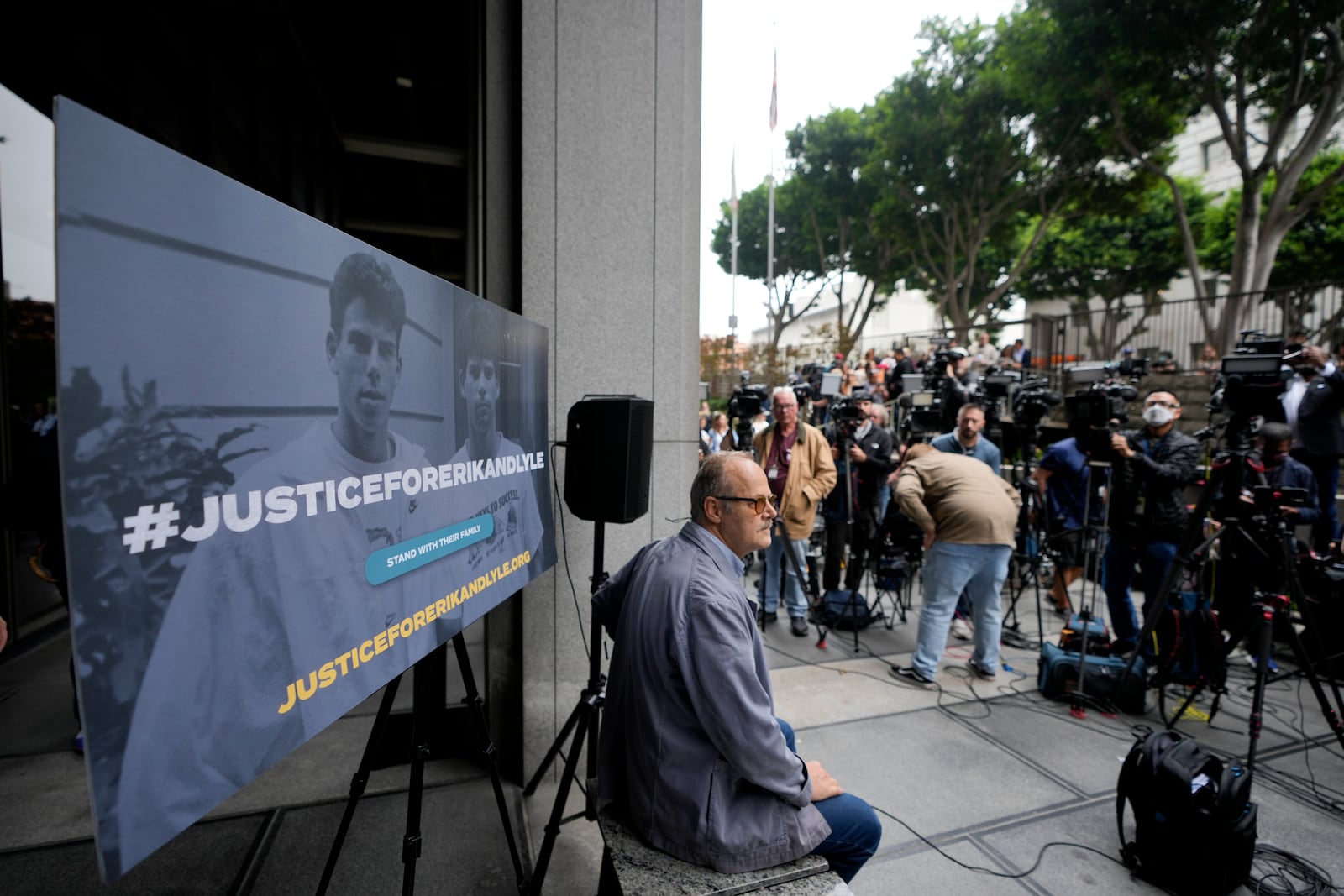 A sign is placed before a press conference to announce developments on the case of brothers Erik and Lyle Menendez, Wednesday, Oct. 16, 2024, in Los Angeles. (AP Photo/Damian Dovarganes)