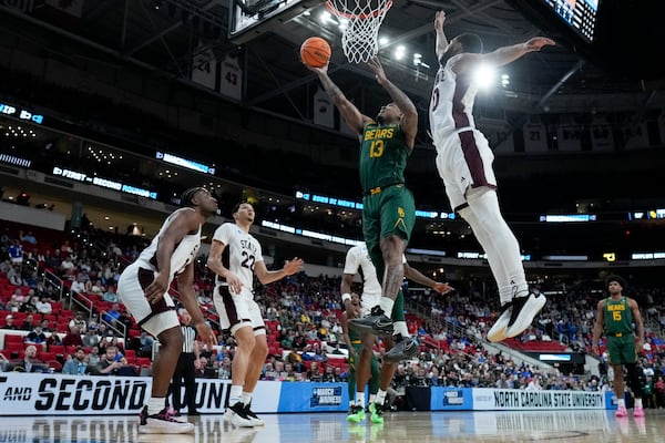 Baylor guard Langston Love drives to the basket past Mississippi State guard Claudell Harris Jr. during the first half in the first round of the NCAA college basketball tournament, Friday, March 21, 2025, in Raleigh, N.C. (AP Photo/Chris Carlson)