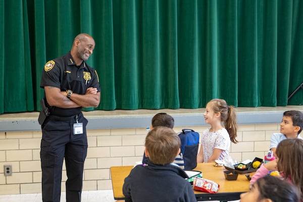 DeKalb County Schools Police Chief Tracey Whaley chats with students at Ashford Park Elementary during lunch on Monday, Sept. 16, 2024. (Jenni Girtman for the AJC)