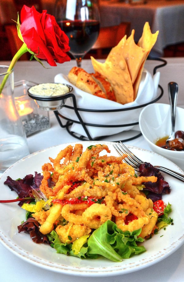 The fried calamari appetizer at Osteria di Mare is served on a bed of greens and tossed with a white wine-pepperoncini reduction. CHRIS HUNT / SPECIAL