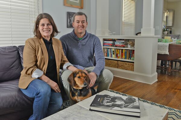 Mara Dodson and Doug LeGette sit in their living room with their dog, Buddy. Mara is a consultant  for The Moss Group while Doug is a special education teacher. Their Craftsman bungalow in Atlanta's Edgewood neighborhood was built in 1925 and renovated in 2016 by Joe Thomas of Elemental Green Homes .