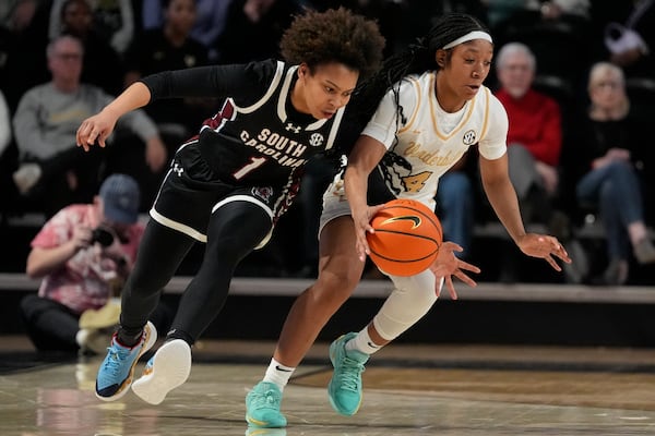 Vanderbilt guard Madison Greene (4) steals the ball from South Carolina guard Maddy McDaniel (1) during the second half of an NCAA college basketball game Sunday, Feb. 23, 2025, in Nashville, Tenn. (AP Photo/George Walker IV)