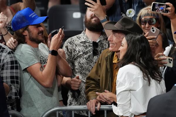 Rep. Alexandria Ocasio-Cortez, D-N.Y., right, takes a photo with a supporter after speaking during a "Fighting Oligarchy" tour event at Arizona State University, Thursday, March 20, 2025, in Tempe, Ariz. (AP Photo/Ross D. Franklin)