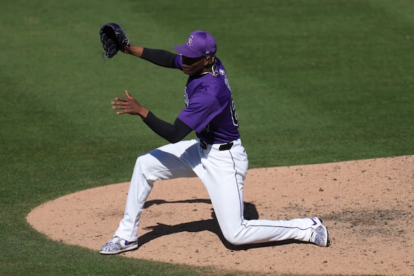 Colorado Rockies pitcher Jefry Yan celebrates a strikeout against Seattle Mariners Jacob Nottingham during the seventh inning of a spring training baseball game, Sunday, March 2, 2025, in Scottsdale, Ariz. (AP Photo/Ross D. Franklin)