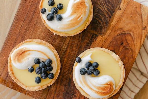 Theo’s Brother’s Bakery has a selection of seasonal goodies, such as these tarts with lemon curd and blueberries. Courtesy of Peyton Jessica Photography