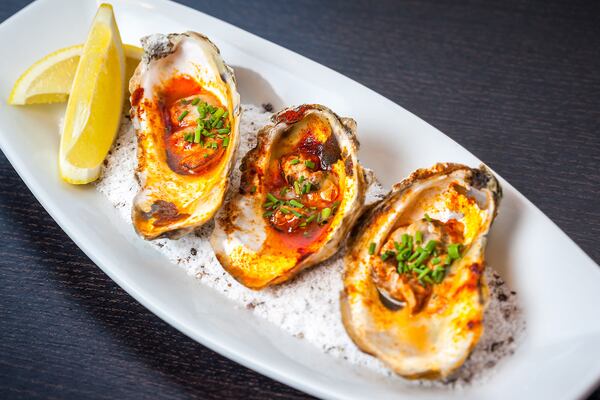 The grilled oysters with lemon butter and smoked paprika at Simon's Restaurant in Midtown. PHOTO CREDIT: Christopher Watkins