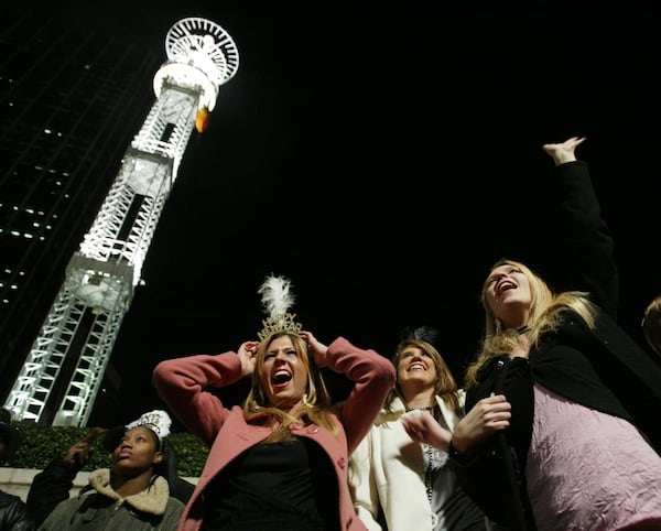 051231 - ATLANTA, GA - In town from Pickens County for the Peach Drop festivities, Britney Mooney, 17, left, (cq) Erin Carpenter, 16, center, (cq) and Samantha Campana, 15, right, (cq) cheer as Luna Halo takes the stage about two and a half hours before the peach drops marking the New Year on Saturday, Dec. 31, 2005.  (JENNI GIRTMAN/STAFF)