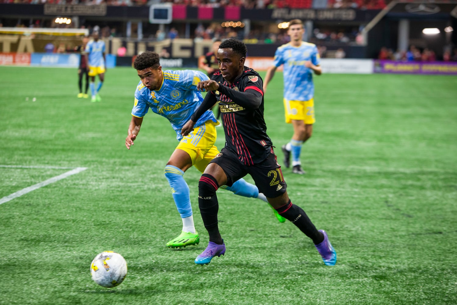 Edwin Mosquera, forward for Atlanta United, dribbles the ball with pressure from Philadelphia Union fullback Nathan Harriel. CHRISTINA MATACOTTA FOR THE ATLANTA JOURNAL-CONSTITUTION.