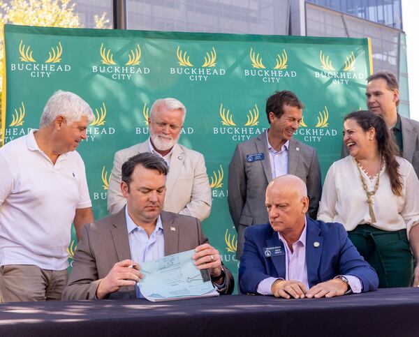 Buckhead City supporters, local residents and several state senators, including Burt Jones, seated left, signed the bill in support of the city onsite, illustrating support in the state Senate, with the bill’s writer Senator Brandon Beach, seated right, at Loudermilk Park in September 2021. Jones, now the lieutenant governor, is perhaps the state's most prominent Republican aligned with former President Donald Trump, and he is pressing new ways to assert his influence ahead of a potential run for governor in 2026. (Jenni Girtman for The Atlanta Journal-Constitution)