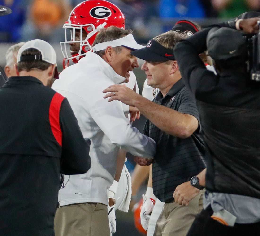 10/30/21 - Jacksonville - Florida Gators head coach Dan Mullen (left) congratulates Georgia Bulldogs head coach Kirby Smart after the annual NCCA  Georgia vs Florida game at TIAA Bank Field in Jacksonville. Georgia won 34-7.  Bob Andres / bandres@ajc.com