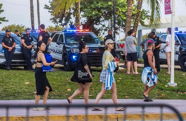 FILE - City of Miami Beach police officers are staged along Ocean Drive during spring break on South Beach, in Miami Beach, Fla., March 9, 2024. (Pedro Portal/Miami Herald via AP, File)