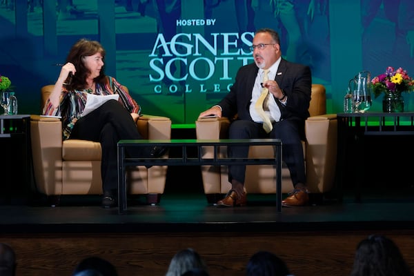 AJC education columnist Maureen Downey listened to U.S. Secretary of Education Miguel Cardona during an discussion organized by The Atlanta Journal-Constitution at Gaines Hall in Agnes Scott College on Monday, July 17, 2023. (Miguel Martinez / miguel.martinezjimenez@ajc.com)